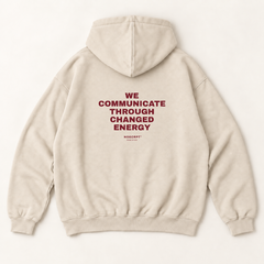 We communicate through changed energy hoodie — Sandshell, back print